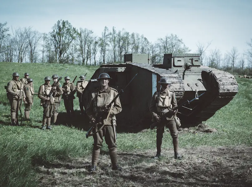 100 days to victory soldiers standing by army tank