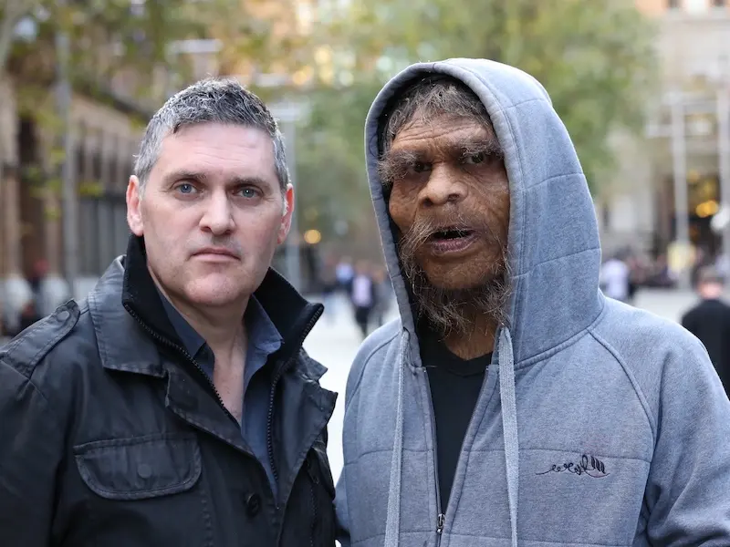Darren Curnoe standing with Actor dressed as Enigma Man in a hoodie