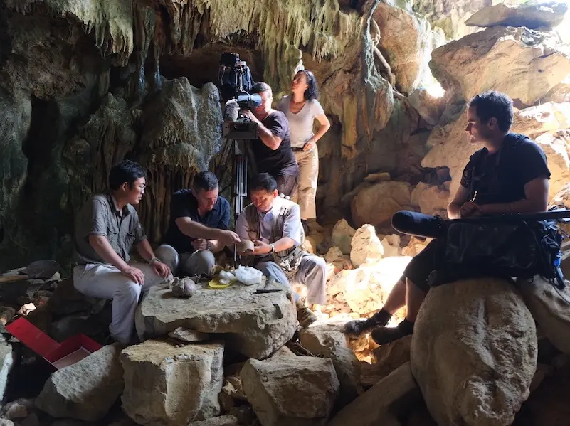 scientist discussing fossil findings in case in south west china