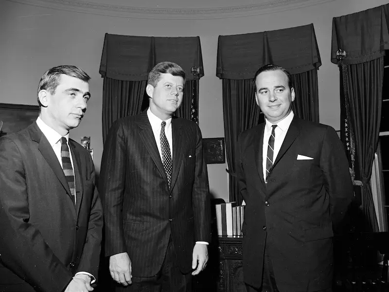 Murdoch Documentary where young Murdoch is standing with JFK in an official room