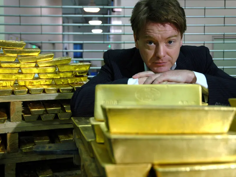 Economist David McWilliams leans on a stack of gold bars
