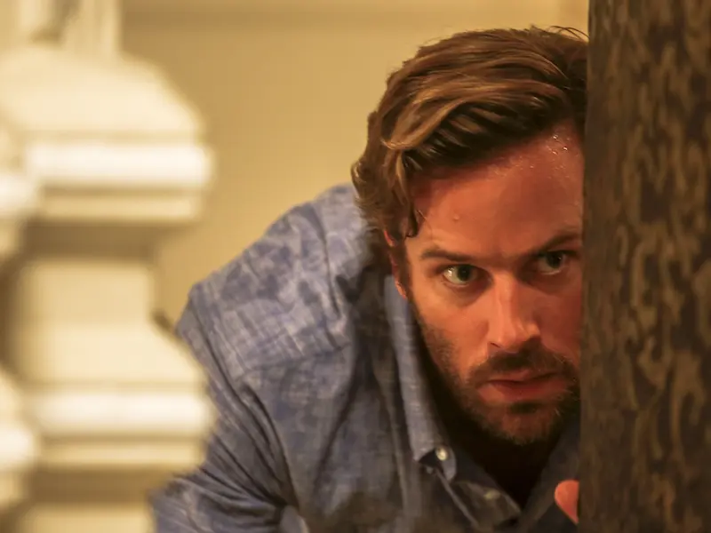 actor arnie hammer peering from behind position of safety from terrorists