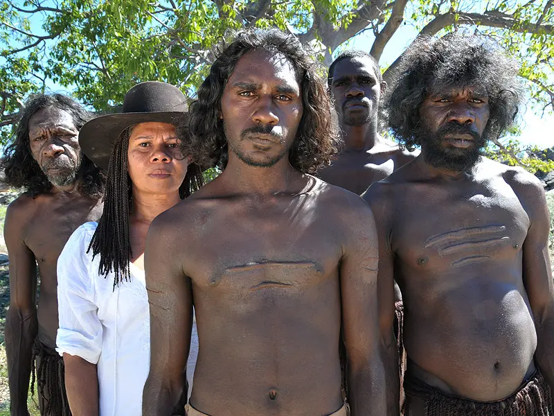 Actors and Director from Jandamarras War standing together by a tree