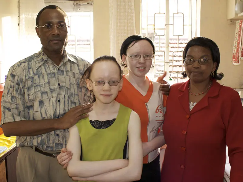 Family portrait of the Kenyan Nzomo family where daughters Grace and Martha have Albinism