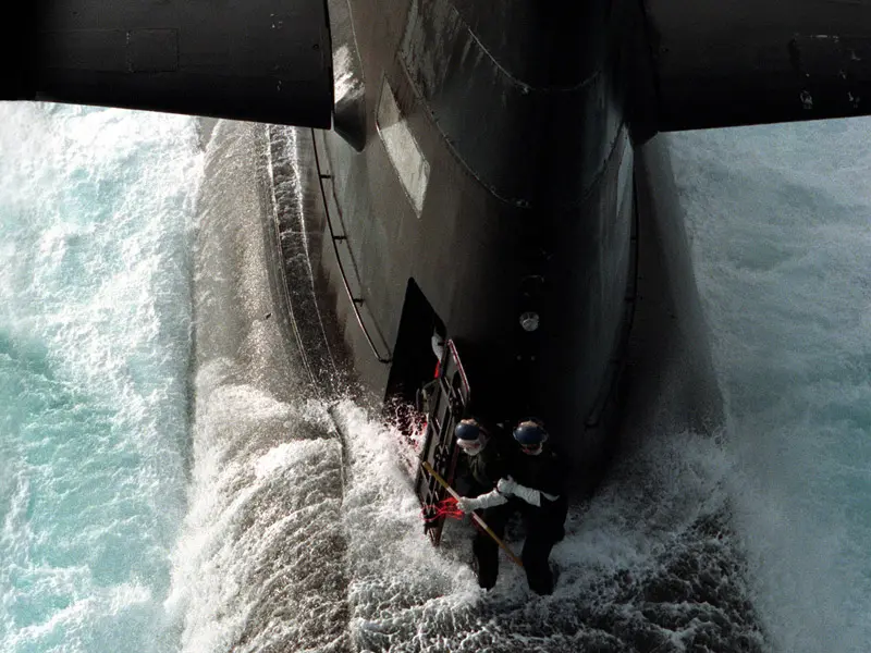 Two submariners on deck on Collins Class Submarine the Rankin on open sea