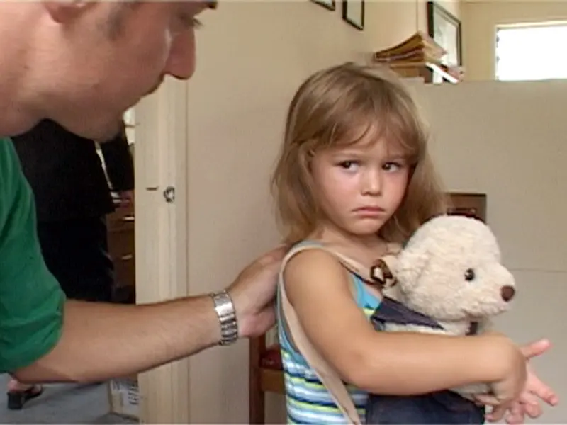 Vincent Gorce puts his hand on Kayla Vince's shoulder while she frowns and holds a teddy